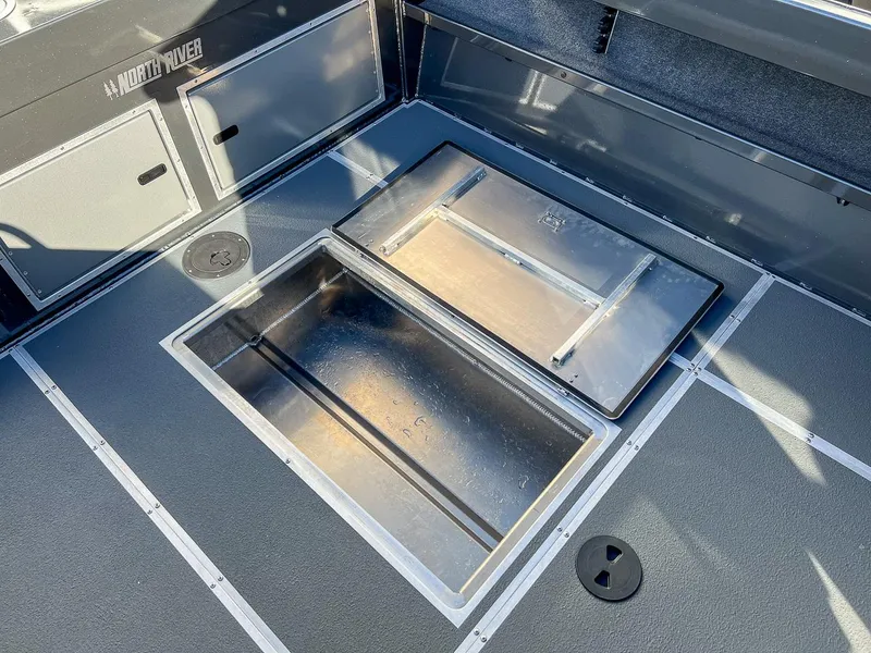 Slide: The Image of 2024 North River 25 Seahawk boat interior with storage compartments open. - 20