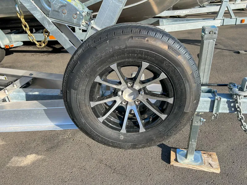 Slide: The Image of Trailer wheel of 2024 North River 25 Seahawk boat on asphalt. - 25