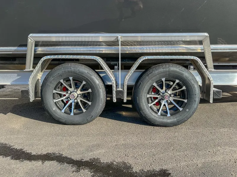 Slide: The Image of 2024 North River 25 Seahawk trailer with dual wheels on asphalt. - 26