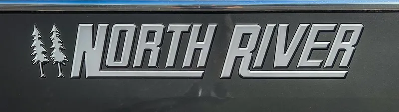 Slide: The Image of North River 25 Seahawk 2024 logo with tree design on dark background - 27