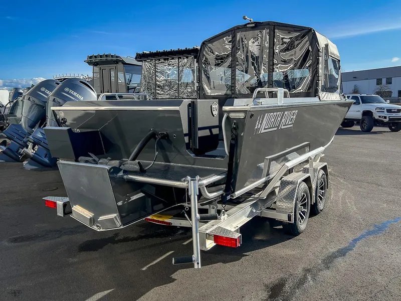 Slide: The Image of 2024 North River 25 Seahawk boat on trailer, parked outdoors. - 3