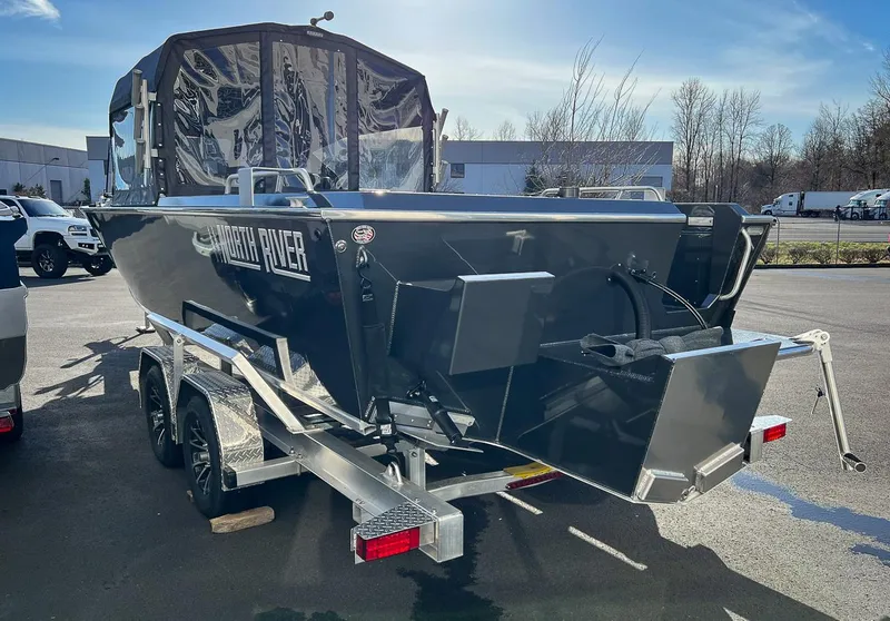 Slide: The Image of 2024 North River 25 Seahawk boat on trailer, parked outdoors. - 5