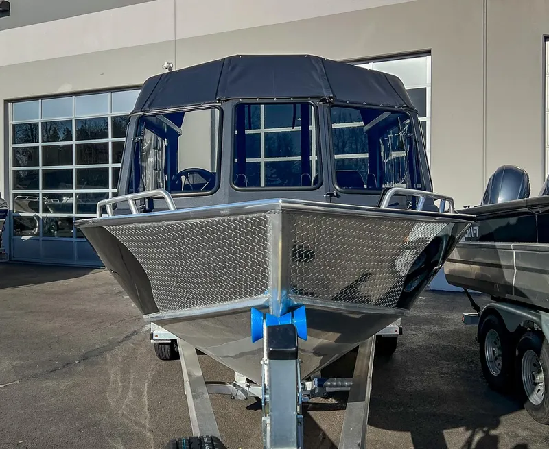 Slide: The Image of 2024 North River 25 Seahawk boat on trailer, front view, in a showroom. - 6
