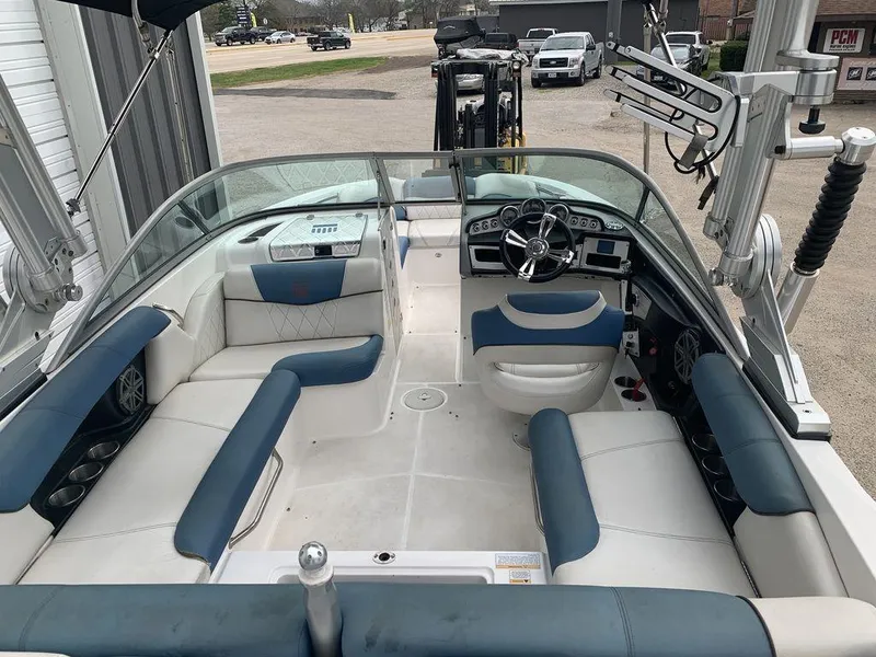 Slide: The Image of 2012 MasterCraft X2 boat interior with blue and white seating, steering wheel, and dashboard. - 3