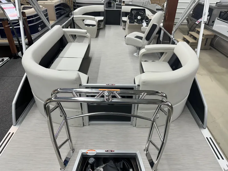 Slide: The Image of 2024 Harris Breeze 230 pontoon boat interior with seating and steering console. - 6