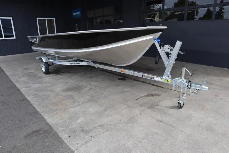 Slide: The Image of 2024 Lowe WV1670 boat on a trailer in a showroom. - 11