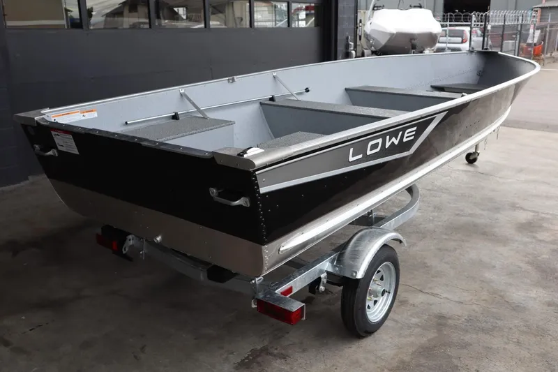 Slide: The Image of 2024 Lowe WV1670 aluminum fishing boat on a trailer in a garage. - 3
