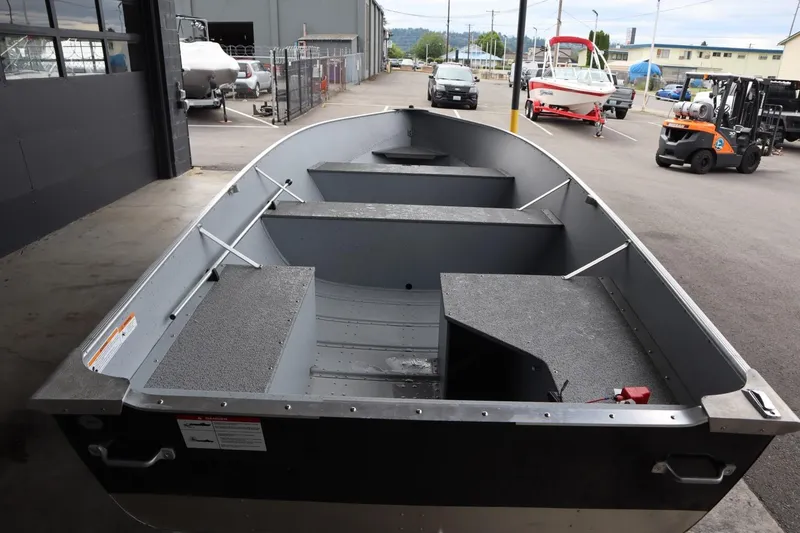 Slide: The Image of 2024 Lowe WV1670 aluminum fishing boat in a marina. - 4