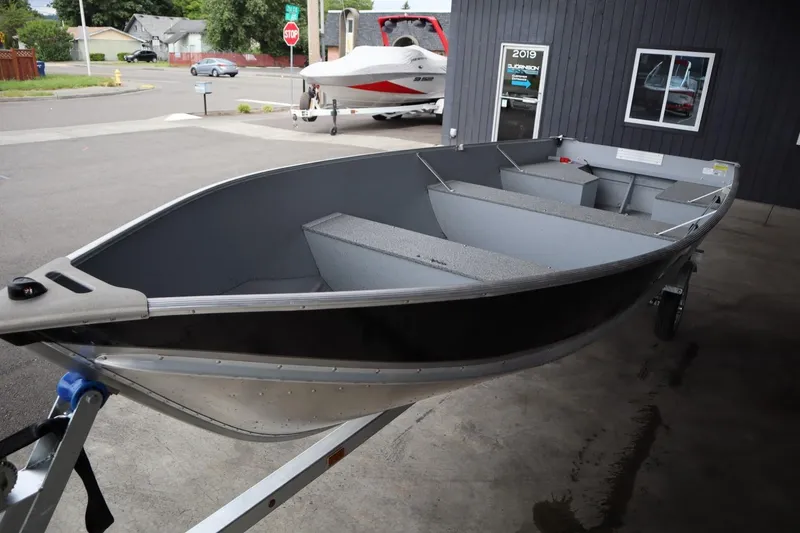 Slide: The Image of 2024 Lowe WV1670 aluminum fishing boat on a trailer in a dealership lot. - 5