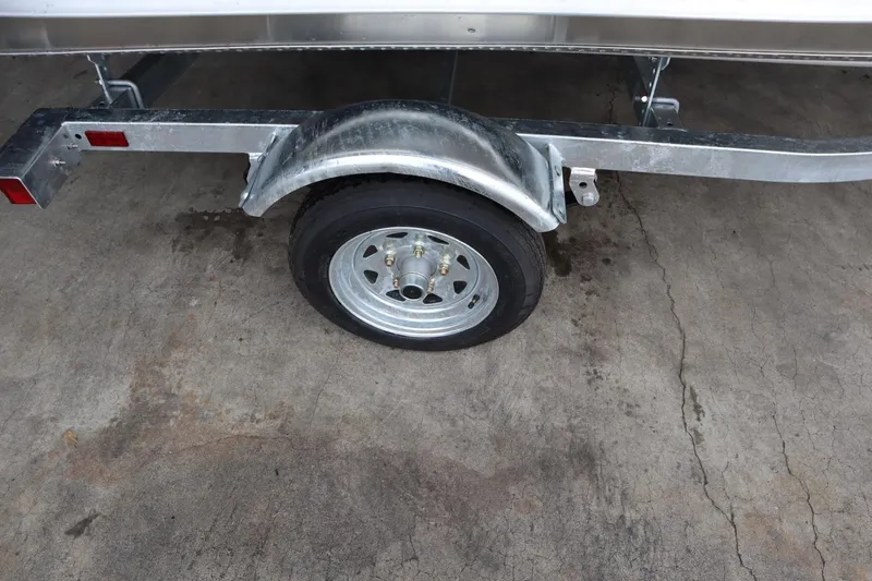 Slide: The Image of 2024 Lowe WV1670 trailer wheel and fender on concrete surface. - 8