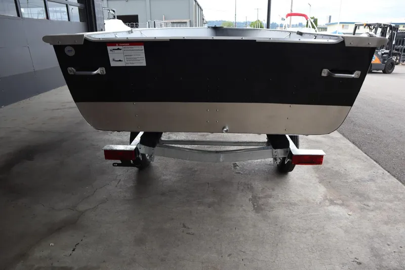 Slide: The Image of 2024 Lowe WV1670 boat on trailer, rear view in a warehouse. - 9