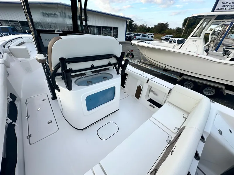 Slide: The Image of 2024 Tidewater 256 LXF boat interior with seating and storage compartments. - 10
