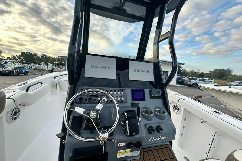 Slide: The Image of 2024 Tidewater 256 LXF boat console with Garmin navigation systems. - 12