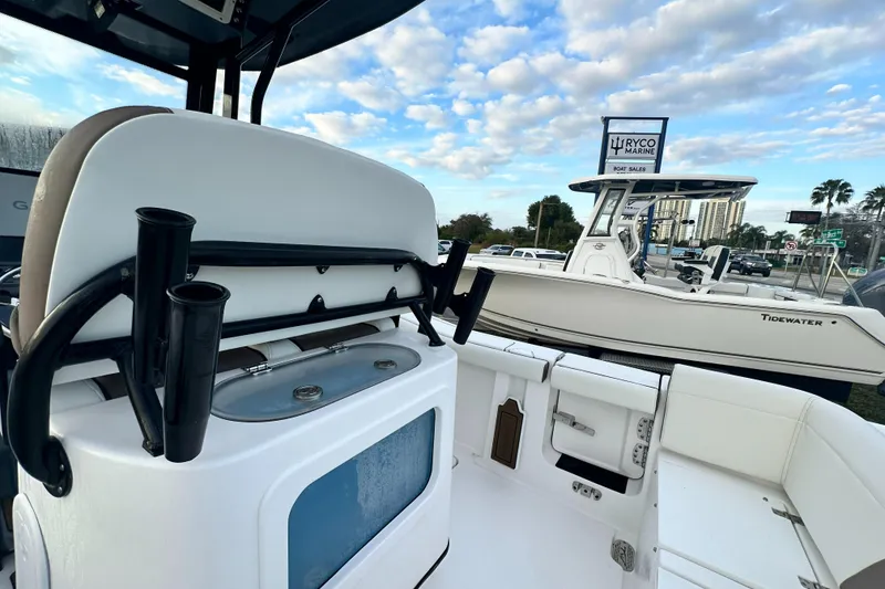 Slide: The Image of 2024 Tidewater 256 LXF boat interior with rod holders and seating. - 17