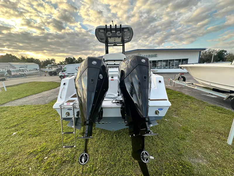 Slide: The Image of 2024 Tidewater 256 LXF boat with dual outboard motors at a dealership. - 5