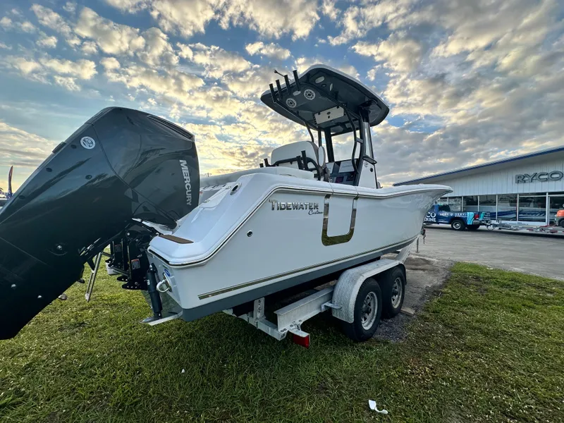 Slide: The Image of 2024 Tidewater 256 LXF boat on trailer with dual Mercury outboard engines. - 6