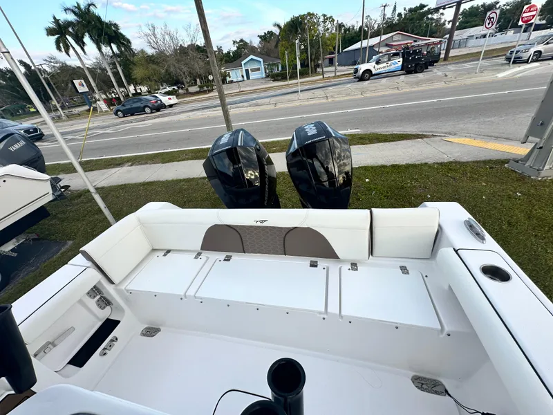 Slide: The Image of 2024 Tidewater 256 LXF boat with dual outboard motors, rear seating, and storage compartments. - 8