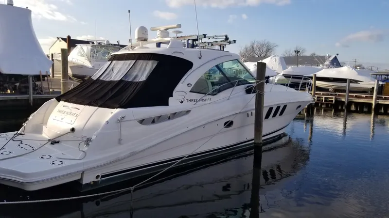 The Image of 2008 Sea Ray 480 Sundancer yacht cruising on open water under a clear sky. - 0