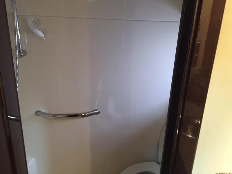 Slide: The Image of Helm of 2008 Sea Ray 480 Sundancer yacht with navigation screens and steering wheel. - 16