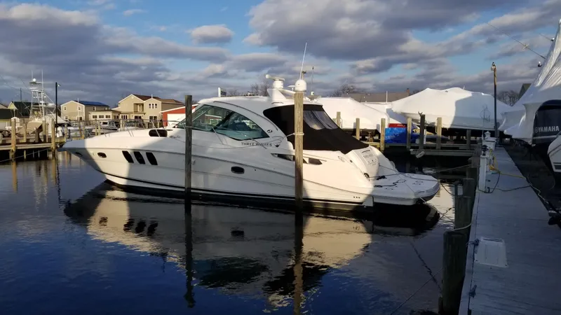 Slide: The Image of 2008 Sea Ray 480 Sundancer yacht cruising on open water under a clear sky. - 2