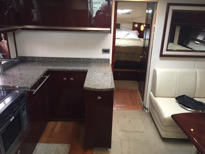 Slide: The Image of Luxurious interior of 2008 Sea Ray 480 Sundancer yacht with modern kitchen and seating area. - 23