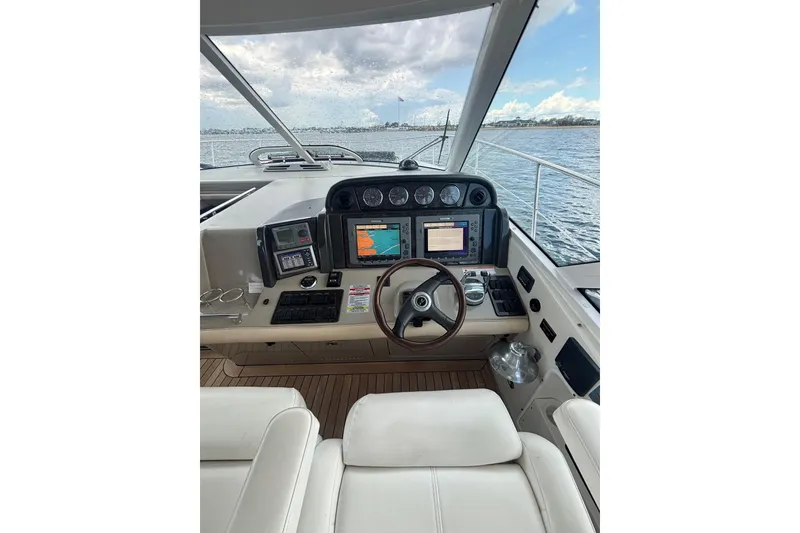 Slide: The Image of 2008 Sea Ray 480 Sundancer yacht cruising on open water under a clear blue sky. - 38