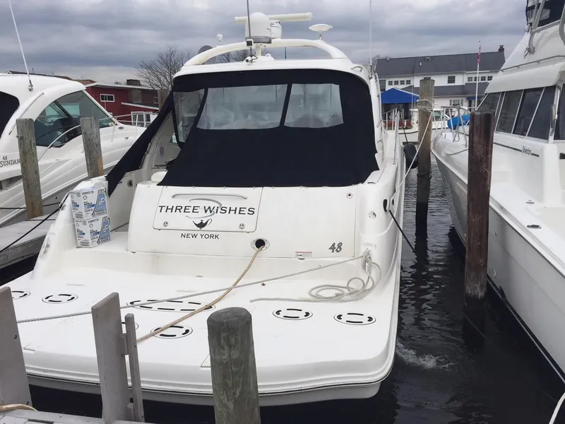 Slide: The Image of 2008 Sea Ray 480 Sundancer yacht cruising on open water, showcasing sleek design and performance. - 4