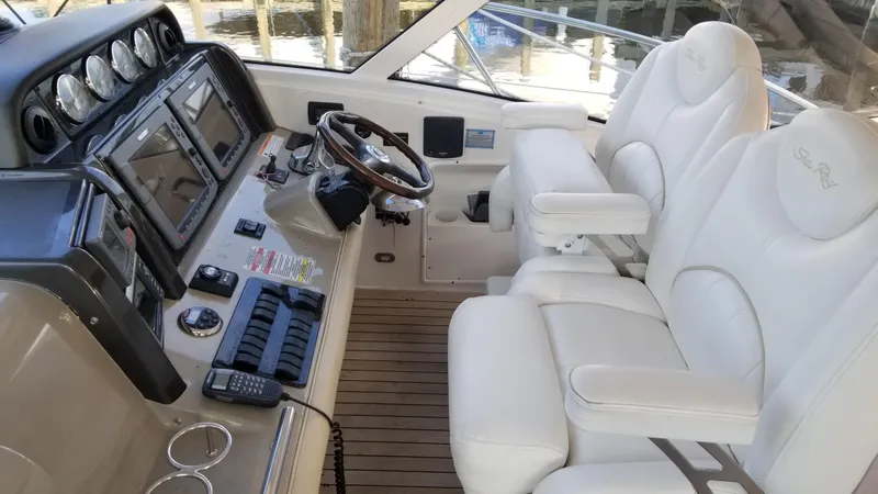 Slide: The Image of 2008 Sea Ray 480 Sundancer cruising on open water, creating a dynamic wake. - 5