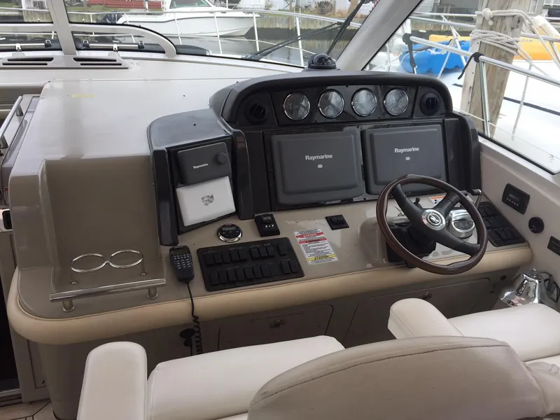 Slide: The Image of 2008 Sea Ray 480 Sundancer cruising on open water, showcasing sleek design and performance. - 6