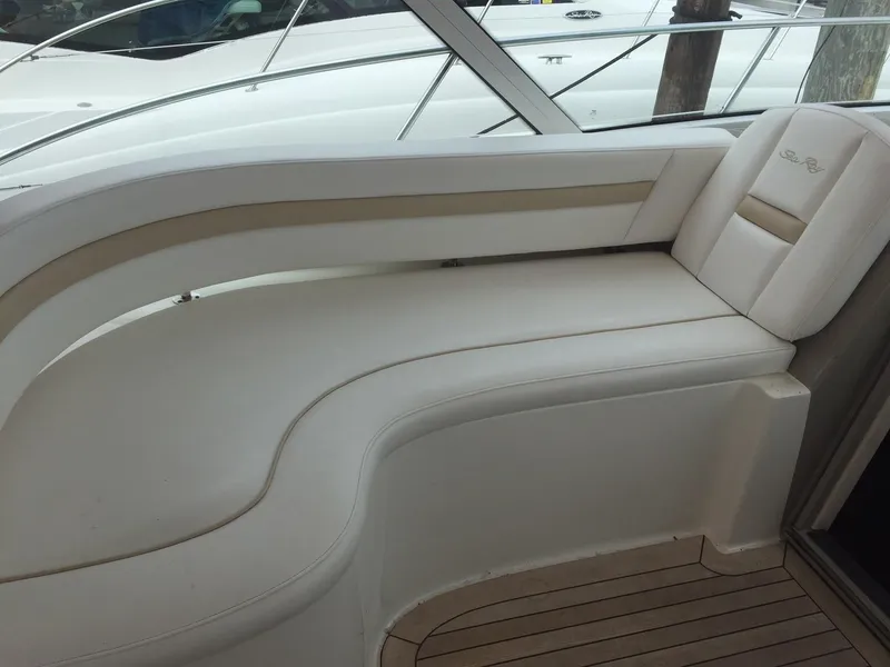 Slide: The Image of 2008 Sea Ray 480 Sundancer cruising on open water under a cloudy sky. - 9