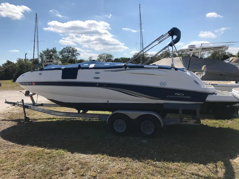 The Image of 2005 Chaparral Sunesta 252 boat on trailer, parked outdoors under a clear sky. - 0
