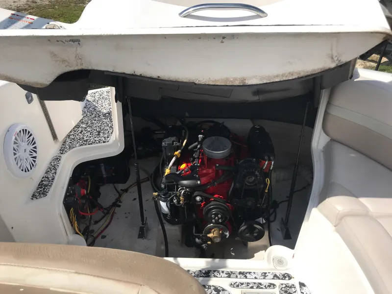 Slide: The Image of 2005 Chaparral Sunesta 252 boat engine compartment with visible red engine components. - 11
