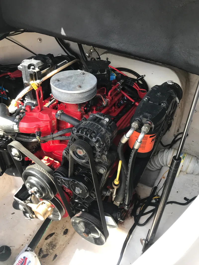 Slide: The Image of Engine of a 2005 Chaparral Sunesta 252 boat, featuring red and black components. - 12