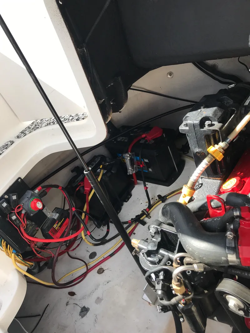 Slide: The Image of 2005 Chaparral Sunesta 252 engine compartment with wiring and battery setup. - 13