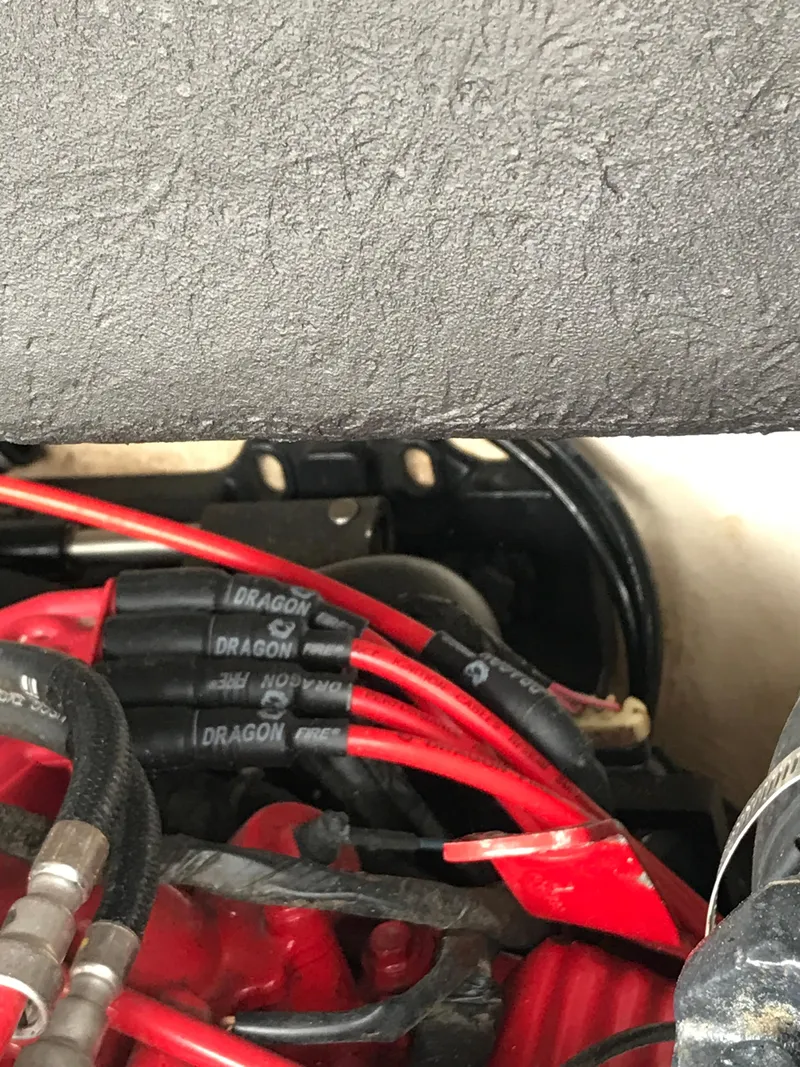 Slide: The Image of Engine components of a 2005 Chaparral Sunesta 252 with visible red and black wiring. - 14