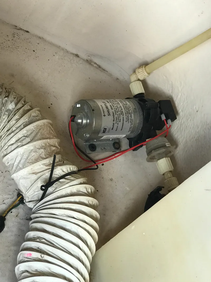 Slide: The Image of 2005 Chaparral Sunesta 252 boat pump and hose system in a compartment. - 15