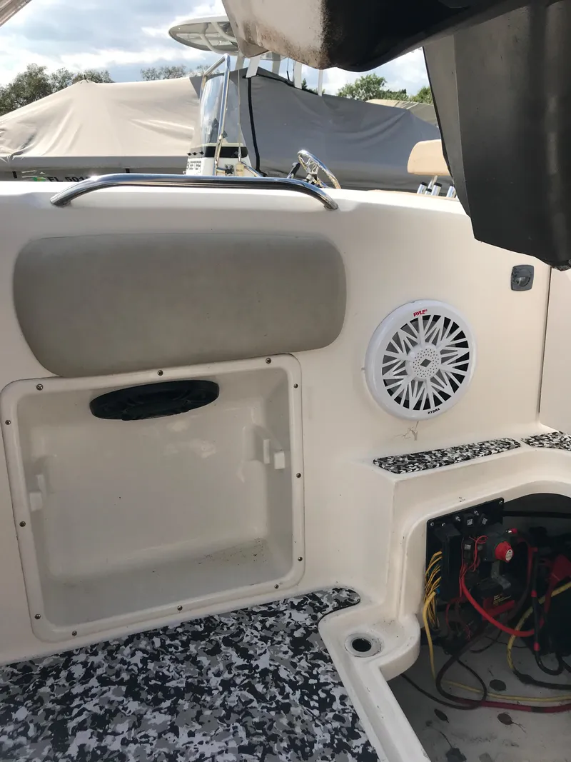 Slide: The Image of 2005 Chaparral Sunesta 252 boat interior with speaker and storage compartment. - 16