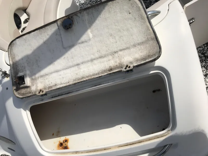 Slide: The Image of Open storage compartment on a 2005 Chaparral Sunesta 252 boat, showing interior and lid. - 27
