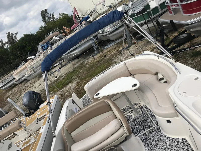 Slide: The Image of 2005 Chaparral Sunesta 252 boat with seating and canopy, parked among other boats. - 30