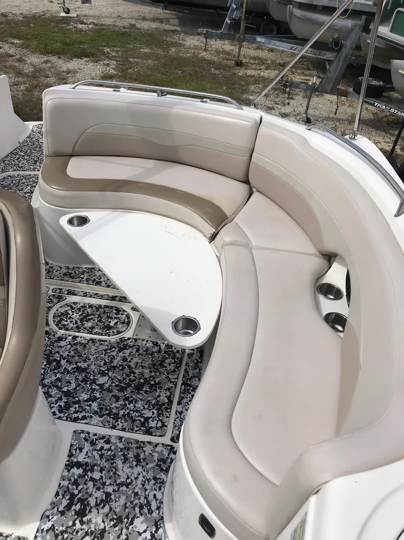 Slide: The Image of 2005 Chaparral Sunesta 252 boat interior with curved seating and table. - 32