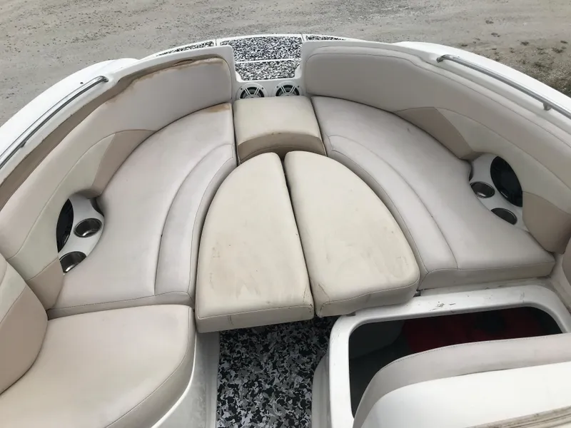 Slide: The Image of 2005 Chaparral Sunesta 252 boat interior with beige seating and cup holders. - 36