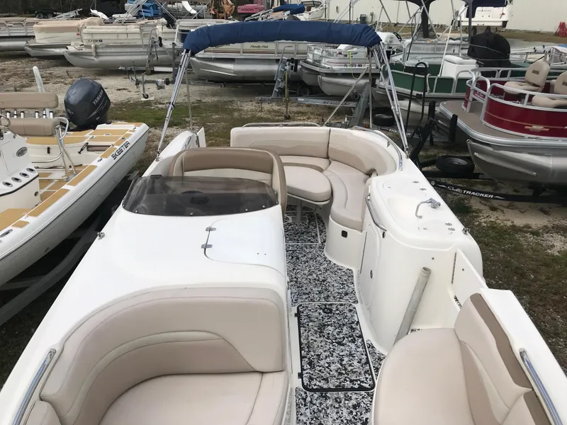 Slide: The Image of 2005 Chaparral Sunesta 252 boat with spacious seating, docked among other boats. - 39