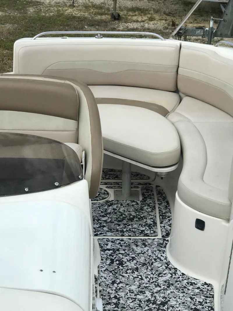 Slide: The Image of 2005 Chaparral Sunesta 252 boat interior with beige seating and patterned flooring. - 40