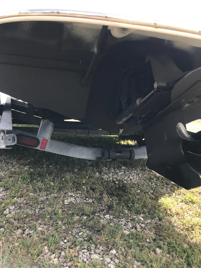 Slide: The Image of 2005 Chaparral Sunesta 252 boat underside on trailer, showing propeller and hull details. - 44