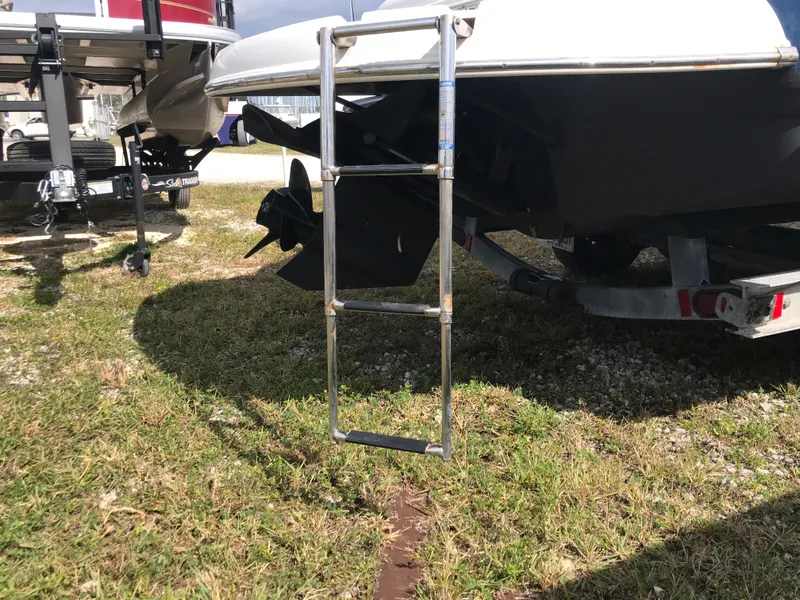 Slide: The Image of Rear view of a 2005 Chaparral Sunesta 252 boat with a ladder and trailer. - 45