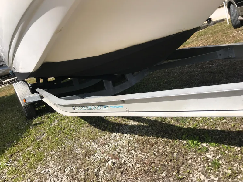 Slide: The Image of 2005 Chaparral Sunesta 252 boat on a MarineMaster trailer, parked on grass. - 49