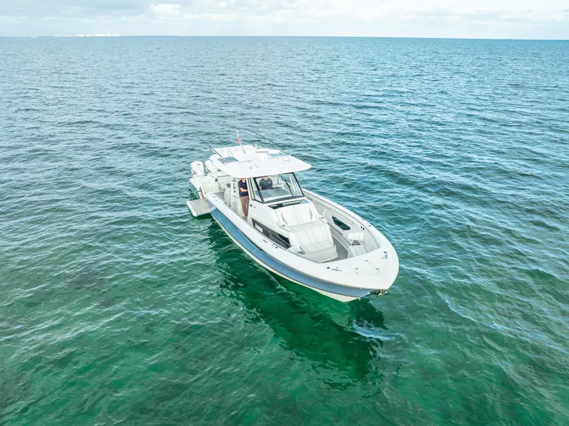 Slide: The Image of 2022 Pursuit 428S boat cruising on open water. - 11