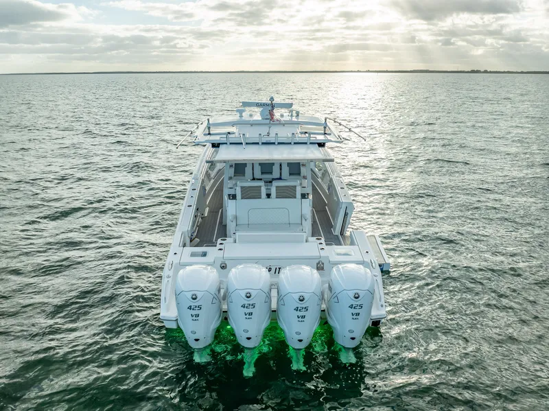 Slide: The Image of 2022 Pursuit 428S boat with quad 425 V8 engines on open water. - 13