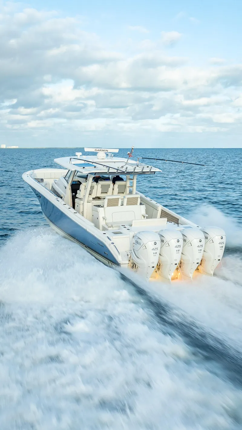 Slide: The Image of 2022 Pursuit 428S boat speeding on open water. - 14