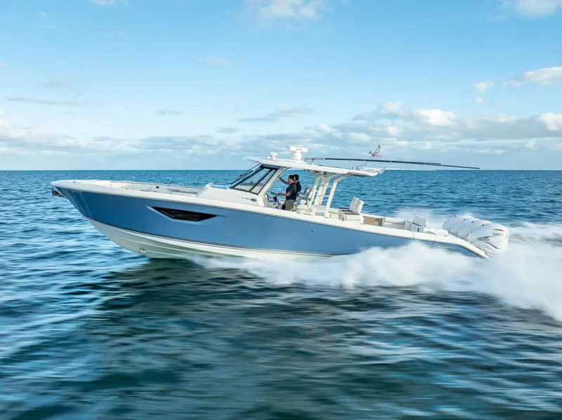 Slide: The Image of 2022 Pursuit 428S boat cruising on open water. - 16